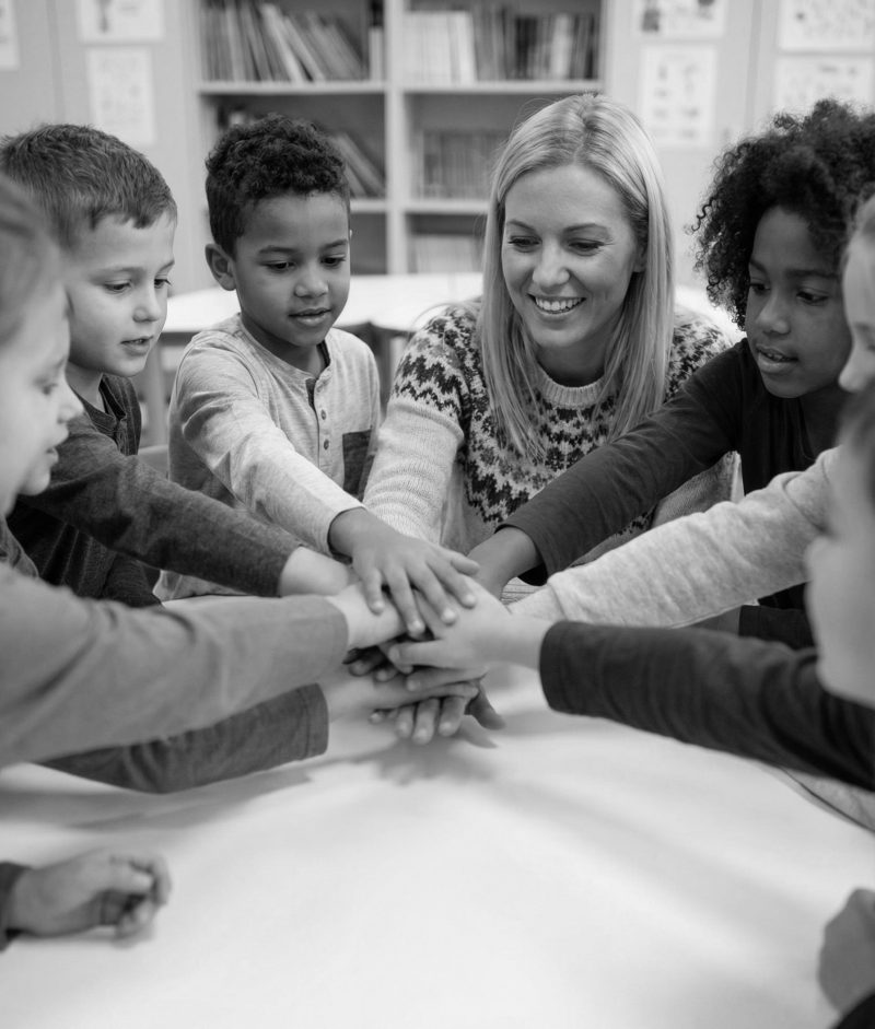 Lärare och elever tillsammans kring ett bord i klassrummet